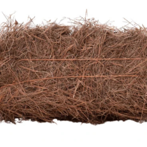 Brown rectangular bale of dry straw seen against a white background.