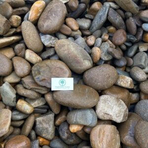 Small white business card resting on a bed of smooth multicolored pebbles; card reads Pine Straw Place Landscaping Supply (logo visible).