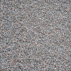 Close-up of a gravel surface with small gray and pink stones.